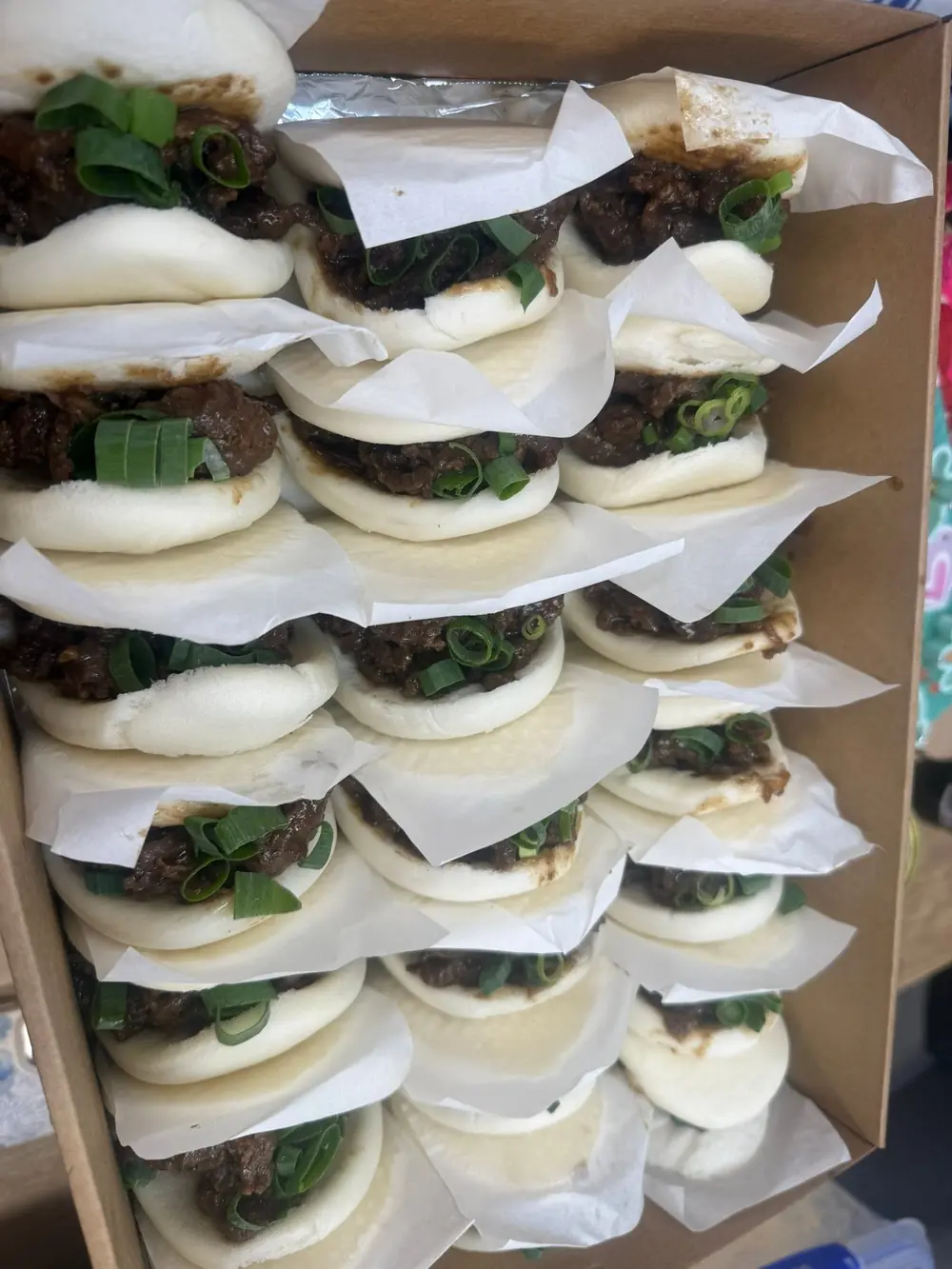 Rows of filled steamed buns packed for a group