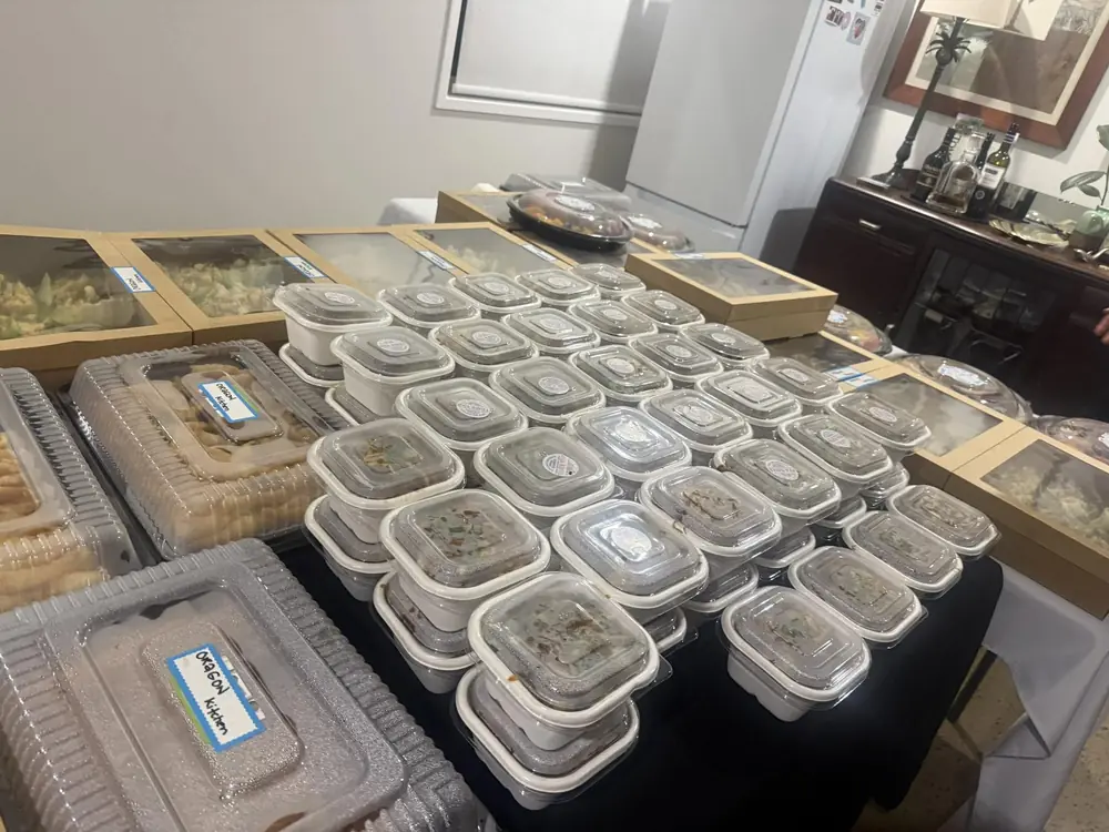 Assorted catering meals and containers arranged across a table